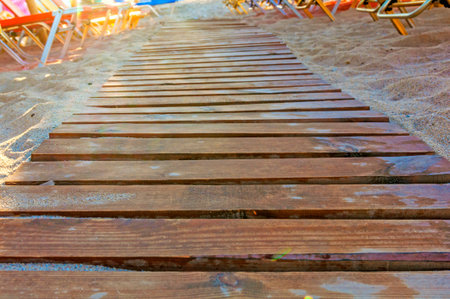 Close up shot of a wooden beach path texture with some sandの写真素材