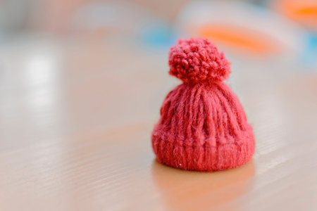 Hedgehog red knitted hat on table