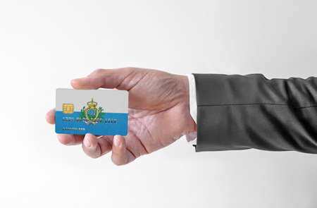 Bank credit plastic card with flag of San Marino holding man in elegant suitの写真素材