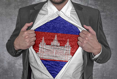 Business man show t-shirt flag of Cambodia rips open his shirtの写真素材