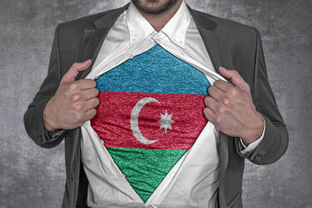 Business man show t-shirt flag of Azerbaijan rips open his shirtの写真素材