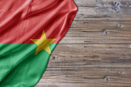 Wooden pattern old nature table board with Burkina Faso flagの写真素材