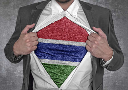 Business man show t-shirt flag of Gambia rips open his shirtの写真素材