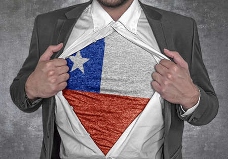 Business man show t-shirt flag of Chile rips open his shirtの写真素材