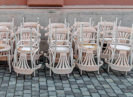 Stack of white chair in the cityの写真素材