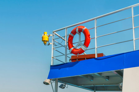 Red lifebuoy on white ferry wallの写真素材