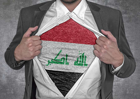 Business man show t-shirt flag of Iraq rips open his shirtの写真素材