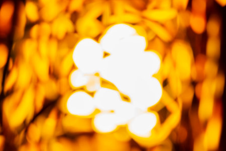 Black and yellow gold with bokeh defocused lights abstract backgroundの写真素材