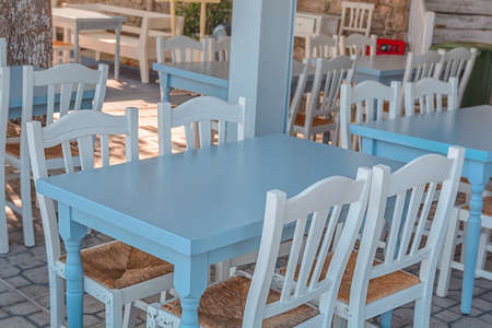 Blue table and white chairs in a typical tavern in Greeceの写真素材