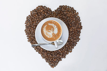 Cappuccino Owl latter art coffee cup and coffee bean hart drawing on white table