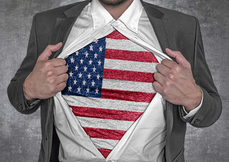 Business man show t-shirt flag of United States rips open his shirtの写真素材