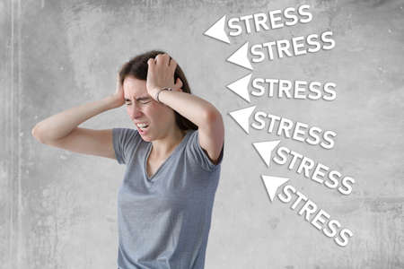 Angry unhappy young stressed businesswoman pulling her hairの写真素材