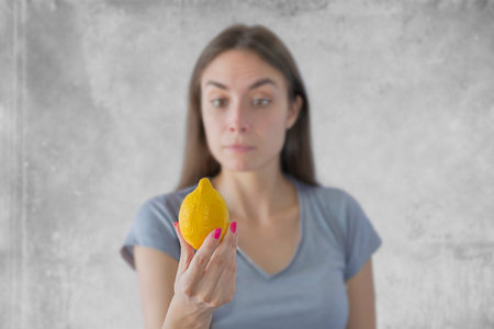 Young beautiful woman with yellow lemon