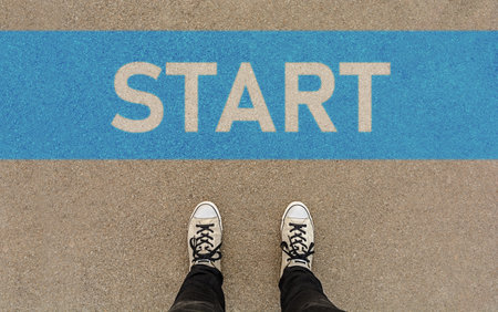 Male sneakers on the asphalt road with drawn word start with blue lineの写真素材