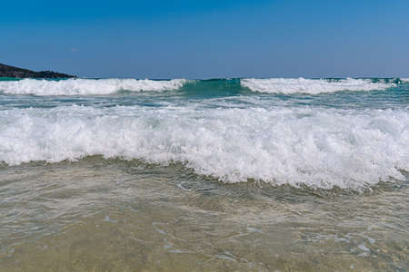 Big foamy wave with blue clean skyの写真素材