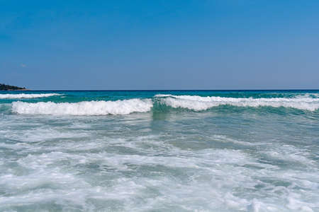 Beauty sea foamy wave with blue clean skyの写真素材