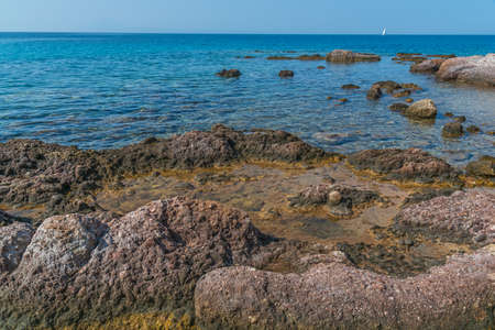 Sea shore stone coastline with clear skyの写真素材
