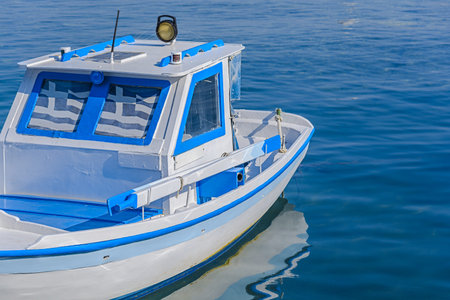 Small white barge in home port on Greek island