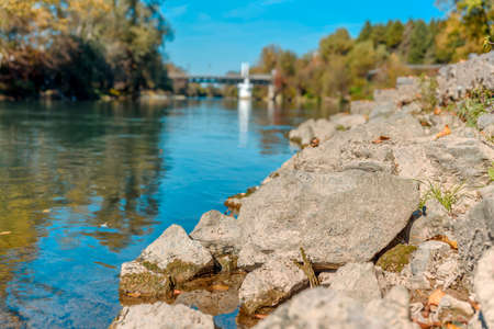 River stone close up with mud and blue sky in the backgroundの写真素材