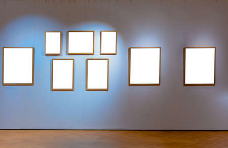 Several old wooden frame in a galery hanging on the wallの写真素材