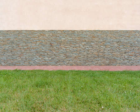 Stone brick wall for place for text, on a sunny day with bit wallの写真素材