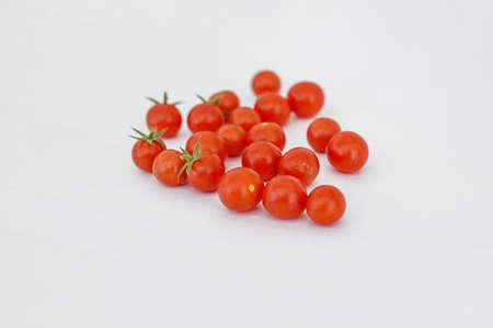 Tasty fresh red cherry tomato on white backgroundの写真素材