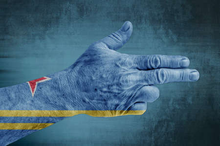 Aruba flag painted on male hand like a gunの写真素材