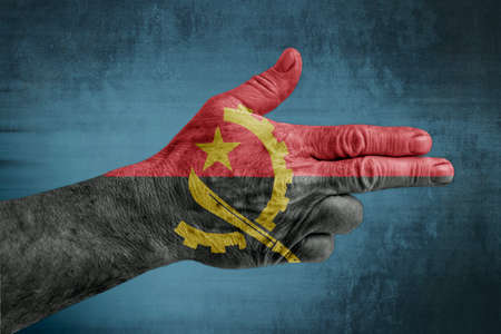 Angola flag painted on male hand like a gunの写真素材
