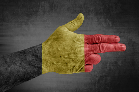 Belgium flag painted on male hand like a gunの写真素材
