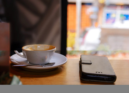 White cup of cappuccino  on a wooden table in cafe shopの写真素材