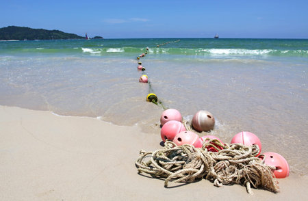 Buoys on sand beach, Patong beach Phuket Thailand の写真素材