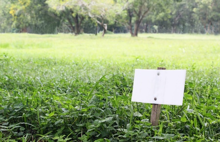 white signboard on grass fieldの写真素材