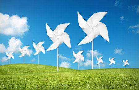paper toy windmill in green grass field