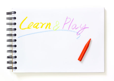 note book with learn and play text over white background 