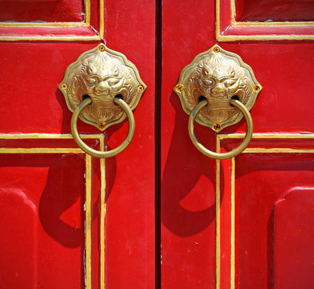 Red chinese door with a lion head.