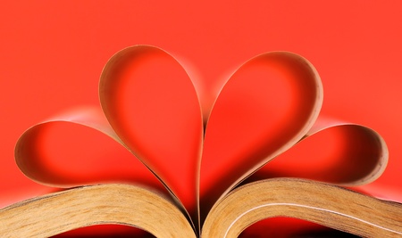 Heart-shaped book on red backgroundの写真素材