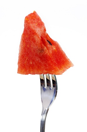 Slice of water-melon with fork on a white backgroundの写真素材
