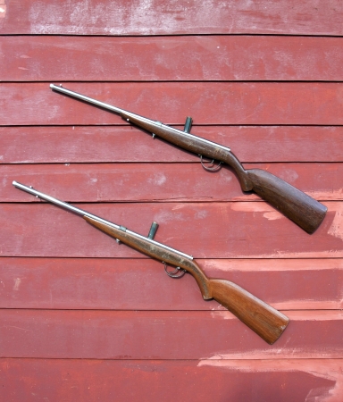sporting gun on the wood wall の写真素材