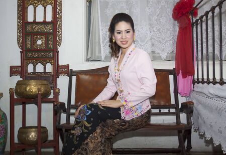 portrait of beautiful asian woman smiling with traditional clothing Peranakan dressの写真素材