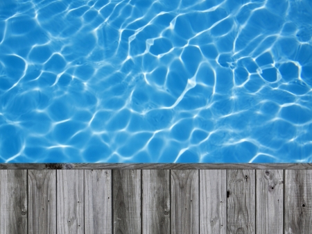 Blue ripped water in swimming pool with wood flooring background for display picture or objectの写真素材