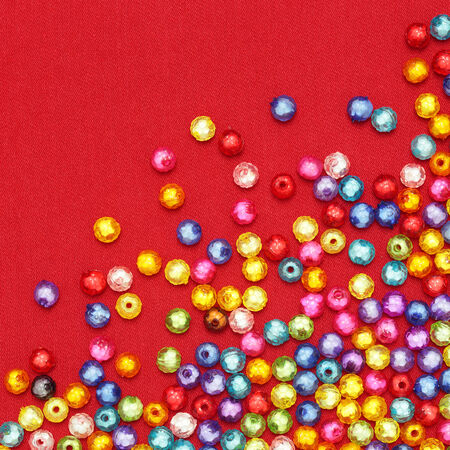 Abstract Colorful beads on red background の写真素材