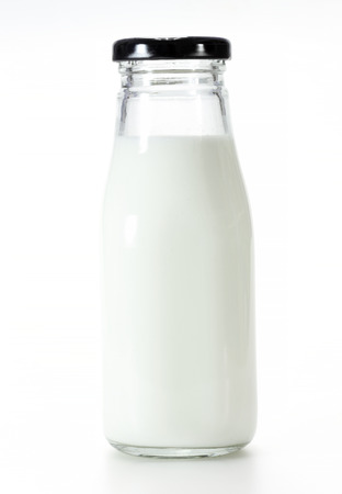 Bottle of milk isolated on white background の写真素材