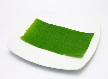 banana leaf on blank plate for edit food or subject onの写真素材