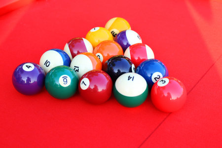 Billards pool game. Color balls in triangle on Red cloth table