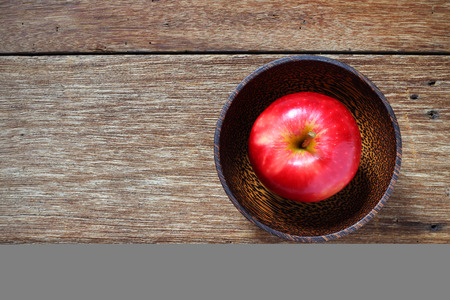 top view apple in wood bowl on tableの写真素材