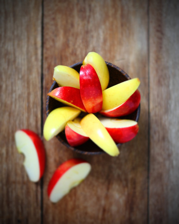 top view apple in wood bowl on tableの写真素材