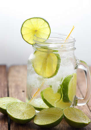 Lemon juice glass and fresh lemons on wood table backgroundの写真素材