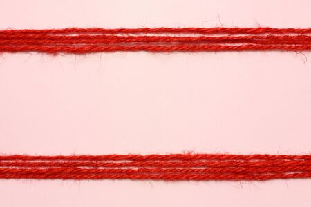 String red as frame on pink backgroundの写真素材