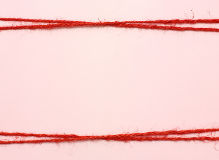 String red as frame on pink backgroundの写真素材