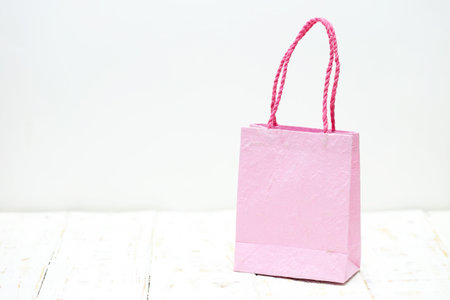 pink Shopping bag on a wooden backgroundの写真素材